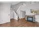 Bright living space with hardwood floors, a cozy fireplace, and staircase to the second floor at 162 Blue Spruce Ct, Highlands Ranch, CO 80126