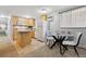 Functional kitchen with light wood cabinetry, an island, and modern appliances near dining area at 1260 N Humboldt St # 1, Denver, CO 80218