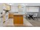 Bright kitchen with light wood cabinets and tile flooring, adjacent to dining area at 1260 N Humboldt St # 1, Denver, CO 80218