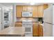 Bright kitchen featuring a microwave, refrigerator, stove and an island at 1260 N Humboldt St # 1, Denver, CO 80218
