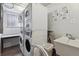 Well-maintained laundry room featuring stacked washer and dryer units and a convenient utility sink at 1260 N Humboldt St # 1, Denver, CO 80218