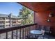 Balcony shows wood paneled walls, seating and views of the surrounding tree line at 305 S Park Ave # 205, Breckenridge, CO 80424