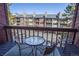 Balcony with seating offering an urban view of neighboring condos and a parking area at 305 S Park Ave # 205, Breckenridge, CO 80424