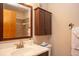 Bathroom featuring a vanity with mirror, dark wood cabinet and a shower with brown tile at 305 S Park Ave # 205, Breckenridge, CO 80424