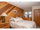 Bedroom featuring a bed, bedside table and a wooden accent wall with a window at 305 S Park Ave # 205, Breckenridge, CO 80424
