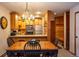Dining area, kitchen view, coat rack and wood bench for functional and cozy living with warm lighting at 305 S Park Ave # 205, Breckenridge, CO 80424