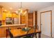 Dining area featuring wood cabinetry, stainless appliances, and a rustic coat rack for an inviting ambiance at 305 S Park Ave # 205, Breckenridge, CO 80424