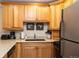 Cozy kitchen with stainless steel appliances, stone countertops, and warm wood cabinets for practical storage at 305 S Park Ave # 205, Breckenridge, CO 80424