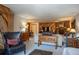 Spacious living room with wood paneling, stone fireplace, comfortable seating, and stylish decor at 305 S Park Ave # 205, Breckenridge, CO 80424