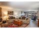 Inviting living room with comfortable seating, a rustic stone fireplace, and a vibrant Persian rug at 305 S Park Ave # 205, Breckenridge, CO 80424