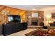 Living room featuring a stone fireplace, a large television and wood paneled accent wall at 305 S Park Ave # 205, Breckenridge, CO 80424