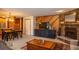 Open living area with dining space, wood accents, stone fireplace and a large coffee table at 305 S Park Ave # 205, Breckenridge, CO 80424