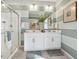 Bathroom with dual sinks, large mirrors, and walk-in shower at 4708 Windmill Dr, Brighton, CO 80601