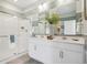 Modern bathroom with double vanity, framed mirrors, and glass-enclosed shower at 4708 Windmill Dr, Brighton, CO 80601