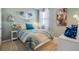 Cozy bedroom with soft blue walls, comfortable bed, and themed decorations at 4708 Windmill Dr, Brighton, CO 80601