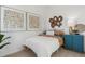 Comfortable bedroom featuring modern artwork, a side table with a lamp, and a neatly made bed at 4708 Windmill Dr, Brighton, CO 80601