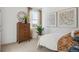 Well-lit bedroom with stylish decor, including a wooden dresser, framed artwork, and a comfortable bed at 4708 Windmill Dr, Brighton, CO 80601