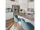 Close up of kitchen island with seating, stainless steel appliances, and light countertops at 4708 Windmill Dr, Brighton, CO 80601