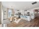 Open-concept kitchen with white cabinets, a center island, and stainless steel appliances next to the dining area at 4708 Windmill Dr, Brighton, CO 80601