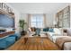 Bright living room with a comfortable sectional, large window, and stylish decor at 4708 Windmill Dr, Brighton, CO 80601