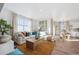 Spacious living room with a sectional sofa, large window, and open access to the dining area at 4708 Windmill Dr, Brighton, CO 80601
