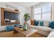 Comfortable living room with modern TV wall, large window, and stylish decor at 4708 Windmill Dr, Brighton, CO 80601