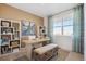 Sunlit office space with a large window, a modern desk, and built-in shelves for organized storage at 4708 Windmill Dr, Brighton, CO 80601