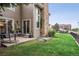 Cozy patio with lawn and chairs in a private backyard, perfect for outdoor relaxation at 14121 E Baltic Pl, Aurora, CO 80014