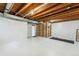 Spacious unfinished basement with white floor, open ceiling and bright light at 14121 E Baltic Pl, Aurora, CO 80014