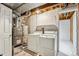 Functional basement laundry area with washer, dryer, water heater, and furnace at 14121 E Baltic Pl, Aurora, CO 80014