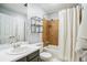 Bathroom with a shower, tub, white shower curtain and neutral tile at 14121 E Baltic Pl, Aurora, CO 80014