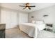 Bedroom boasts a ceiling fan, bedside table, and double closets for ample storage at 14121 E Baltic Pl, Aurora, CO 80014