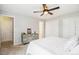 Bright bedroom with a ceiling fan, dresser, and a closet with sliding doors at 14121 E Baltic Pl, Aurora, CO 80014