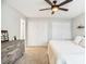 Well-lit bedroom featuring a ceiling fan, carpeted floors, and ample closet space at 14121 E Baltic Pl, Aurora, CO 80014