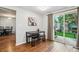 Dining area with wood flooring, a sliding glass door to the backyard and a black table at 14121 E Baltic Pl, Aurora, CO 80014