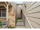 Charming gated entrance with brick and siding, leading to a tranquil courtyard at 14121 E Baltic Pl, Aurora, CO 80014