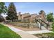 Back view of home with green space and stairs to the upper level at 14121 E Baltic Pl, Aurora, CO 80014
