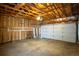 Spacious garage with concrete floor, exposed ceiling, and automatic door perfect for storage or parking at 14121 E Baltic Pl, Aurora, CO 80014