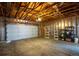 Garage with exposed ceiling and automatic door provides secure parking and storage space at 14121 E Baltic Pl, Aurora, CO 80014