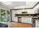Galley kitchen with stainless steel appliances and a sliding glass door leading to a patio at 14121 E Baltic Pl, Aurora, CO 80014