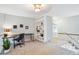 A loft with carpet flooring, desk, chair, bookcase, and railing overlooking the level below at 14121 E Baltic Pl, Aurora, CO 80014
