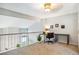 A loft with carpet flooring, a railing overlooking the level below and a desk and chair at 14121 E Baltic Pl, Aurora, CO 80014