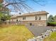 Backyard featuring a rock retaining wall and well manicured lawn at 2517 E Egbert St, Brighton, CO 80601