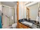 Bathroom featuring shower with sliding glass doors, granite counters and wood cabinets at 2517 E Egbert St, Brighton, CO 80601