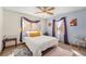 Cozy bedroom featuring two windows and an area rug at 2517 E Egbert St, Brighton, CO 80601