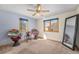 Bedroom featuring neutral carpet, ceiling fan, two windows and a full length mirror at 2517 E Egbert St, Brighton, CO 80601