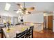 Open dining area with ceiling fan and natural light at 2517 E Egbert St, Brighton, CO 80601