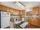 Functional kitchen with wooden cabinets and granite countertops at 2517 E Egbert St, Brighton, CO 80601