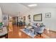 Bright living room featuring hardwood floors, skylights, and modern decor at 2517 E Egbert St, Brighton, CO 80601