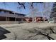 View of the backyard and neighboring buildings, partially obscured by the bare trees at 1105 Bacchus Dr # F8, Lafayette, CO 80026